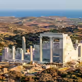 Reconstructed marble columns and walls of the ancient Temple of Demeter at Gyroulas, Naxos, with the Cycladic landscape behind