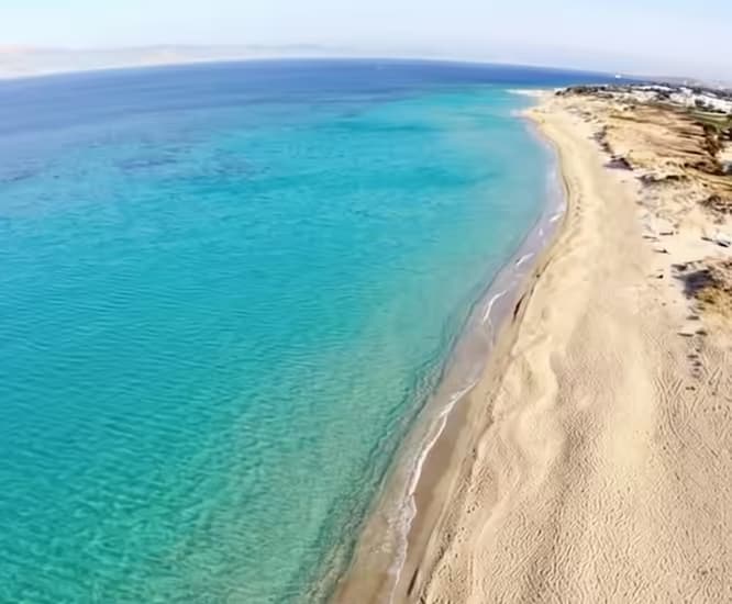 Plaka beach on Naxos with 3 km of fine white sand and clear turquoise Aegean water, the longest beach in the Cyclades, Greece