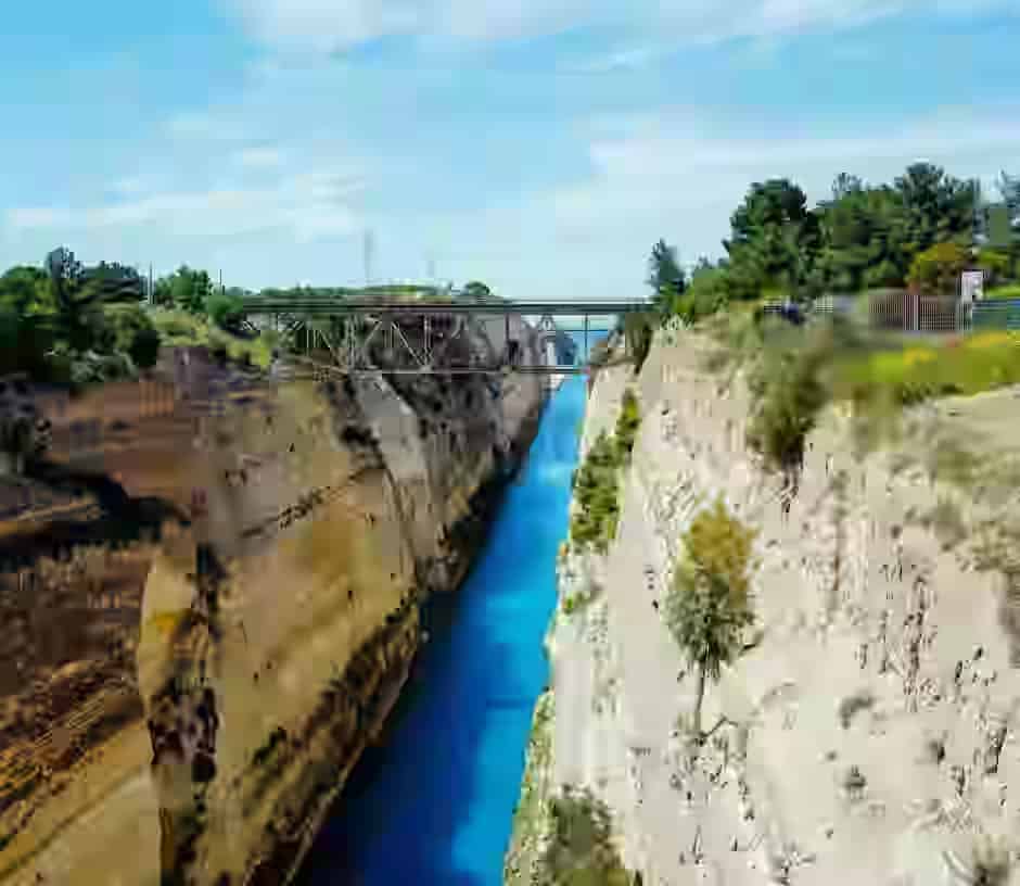 Aerial view of the narrow Corinth Canal with turquoise water and steep limestone cliffs, a famous road trip stop when driving a rental car from Athens to Peloponnese.