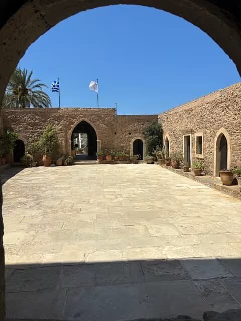 Courtyard of the historic Toplou Monastery (Moni Toplou), East Crete, featuring traditional stone architecture and arched entryways