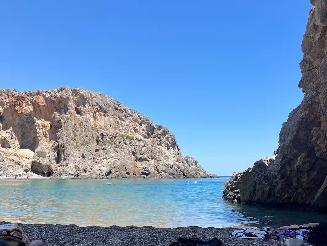 Secluded Agiofarago Beach (Gorge of the Saints) with clear turquoise water and high rocky cliffs, South Crete