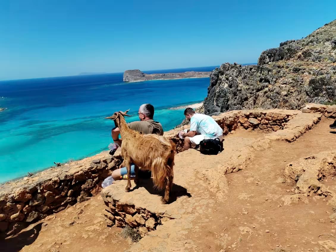 Elevated view of Balos Lagoon and Imeri Gramvousa island, Chania, Northwest Crete, featuring turquoise and deep blue water and a pristine sandy beach