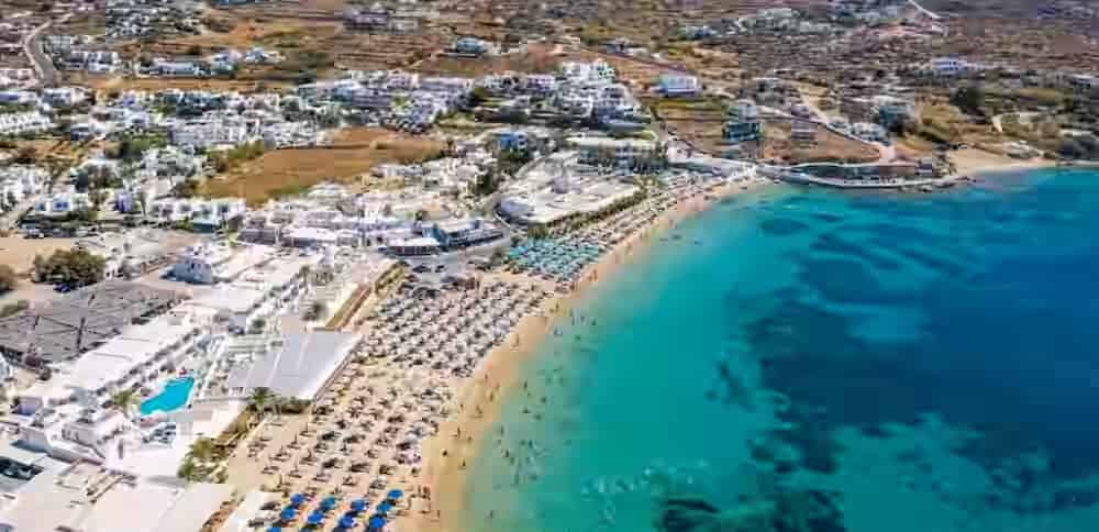 Luftaufnahme des organisierten Sandstrandes Ornos mit türkisfarbenem Wasser auf Mykonos