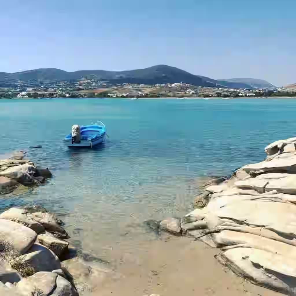 Unique granite rock formations and crystal clear turquoise waters at Kolymbithres Beach in Paros, Greece. Easily accessible with a Karpadu car rental for a perfect day at the beach.
