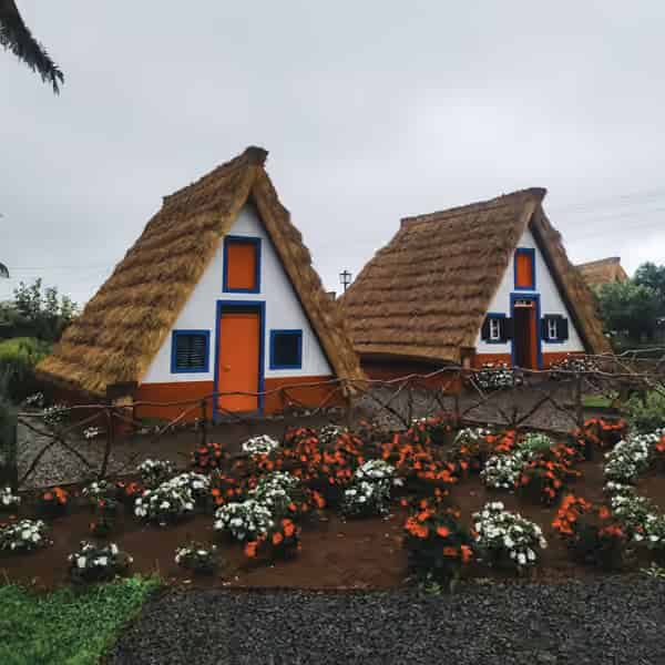 Bunte dreieckige Bauernhäuser mit Strohdach im Dorf Santana, Madeira.